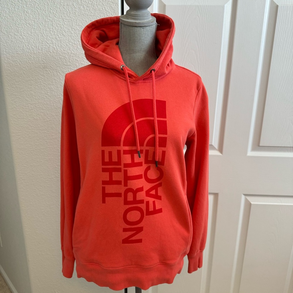The North Face orange hoodie size M with large logo, hood and side pockets
